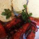 Linguiça assada com cebolas roxas